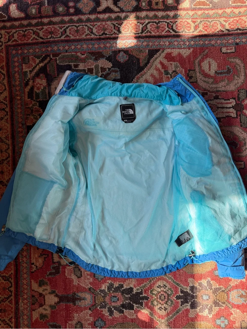 The North Face Women’s Blue and Aqua Hooded Rain Jacket